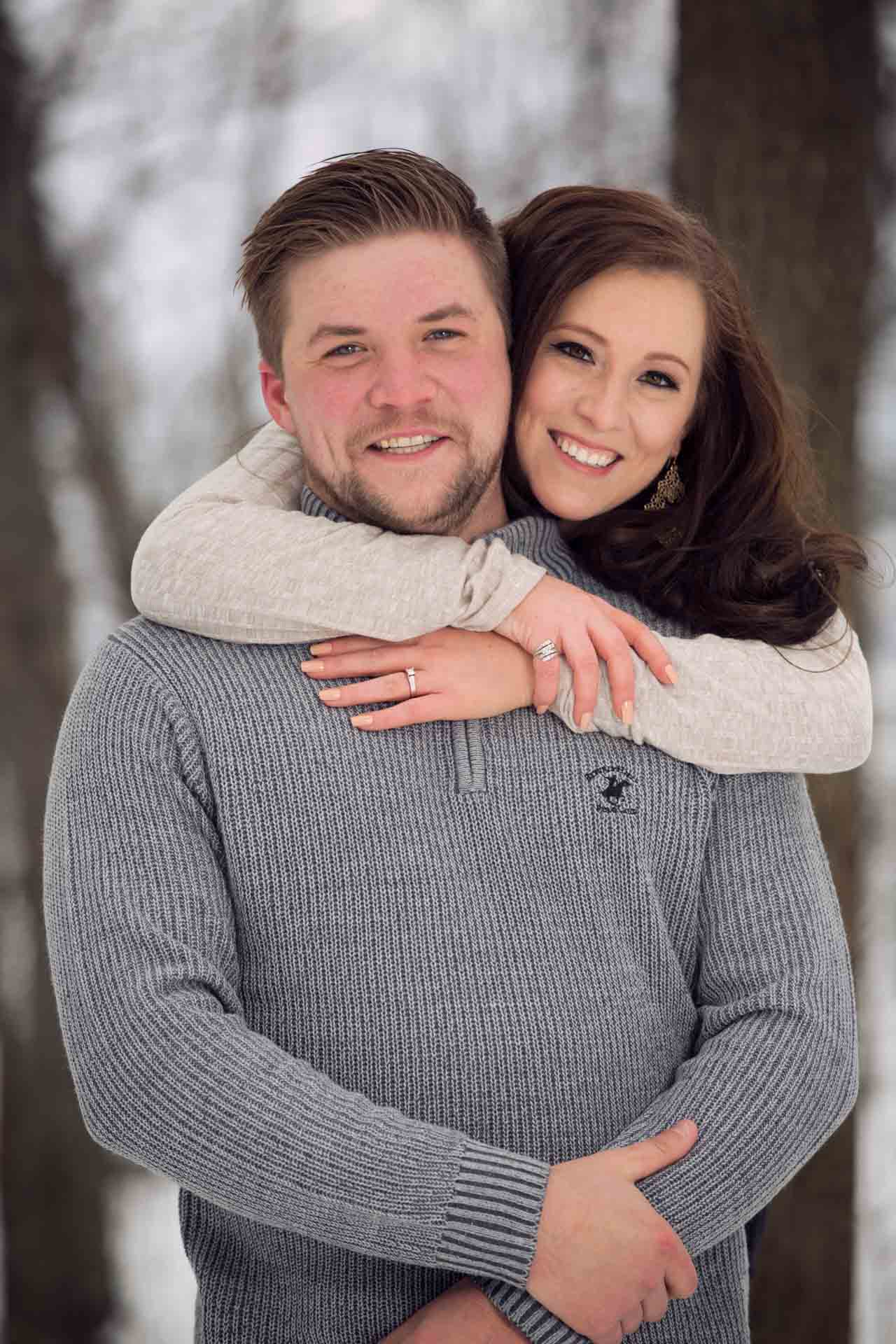 Young couple embraces in love at High Cliff State Park Wisconsin