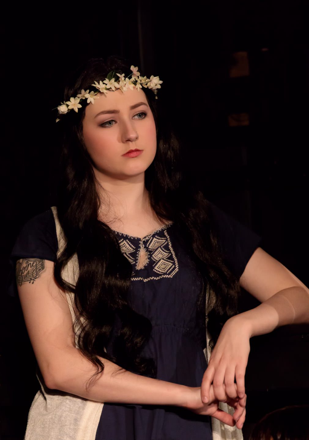 A beautiful young lady plays a flower child in the play Jesus Christ Superstar
