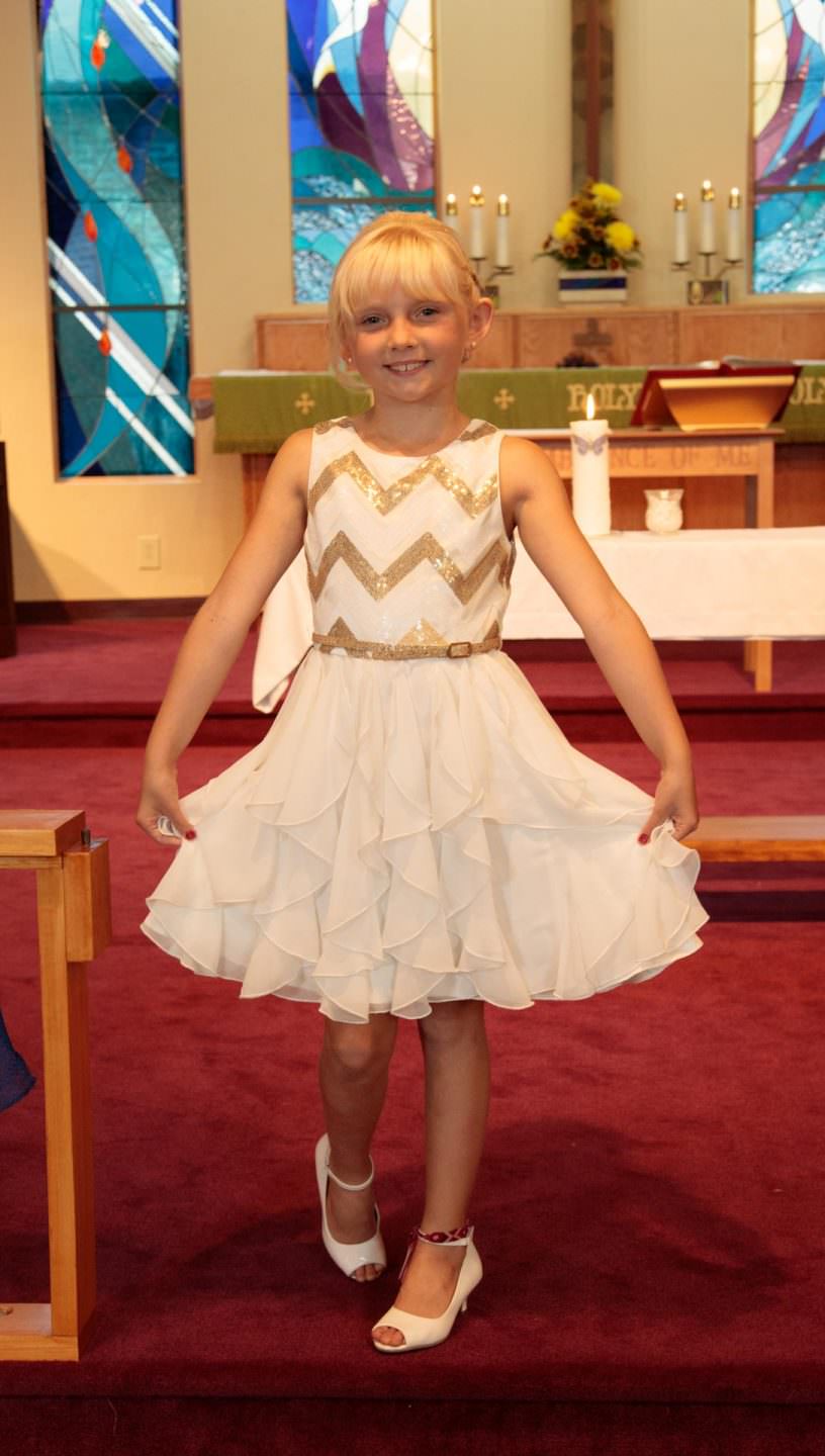 A pretty young girl poses in her wedding dress