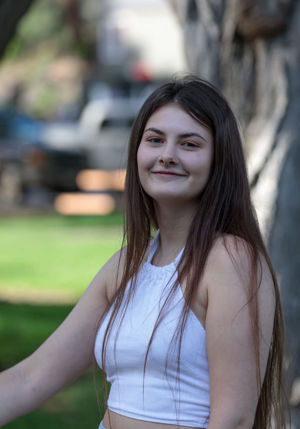 A smiling young lady in a park in Bend Oregon