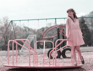 Beautiful young lady on a merry go round